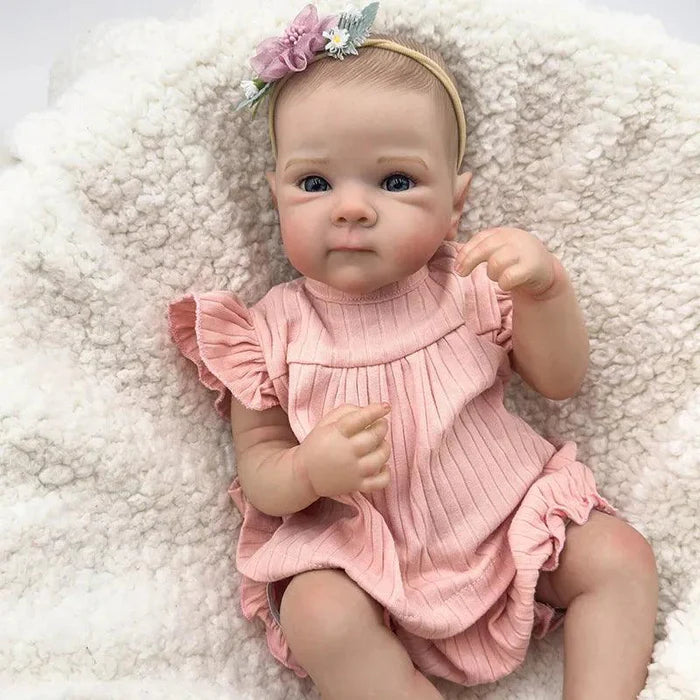 Bebê Reborn Anahi 49cm, boneca artesanal de silicone com olhos claros, pintura realista e acessórios. Perfeita para crianças 3+, ideal para banho e brincadeiras!