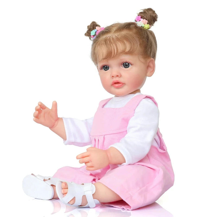 Bebê Reborn Pietra 55cm, boneca realista de silicone com olhos fixos, cabelo enraizado e acessórios. Perfeita para crianças 3+, fomenta cuidado e imaginação!
