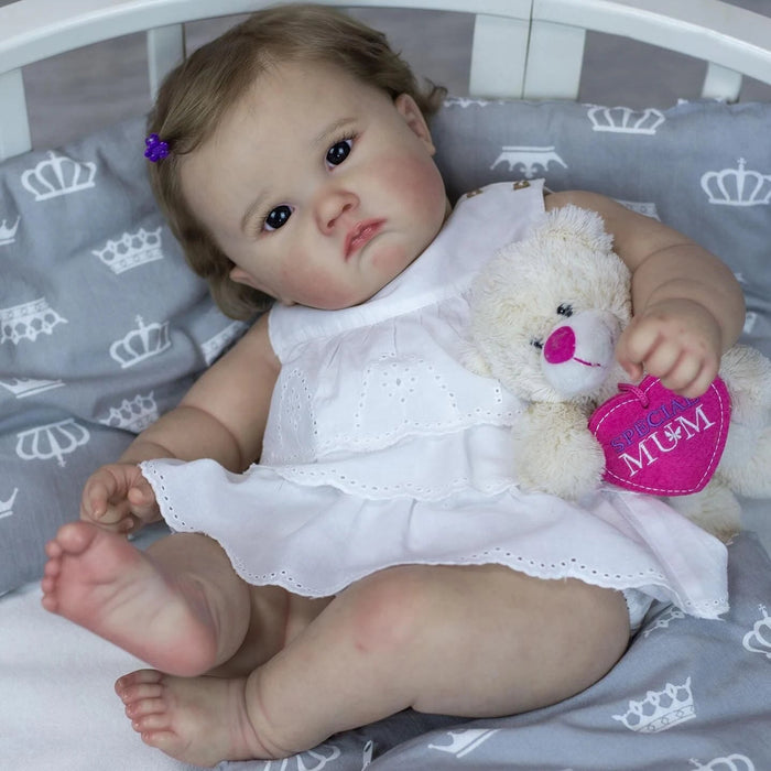 Bebê Reborn Elisa 60cm, boneca realista com corpo macio, olhos vivos, cabelo fio a fio e acessórios. Perfeita para crianças 3+, traz magia e ternura às brincadeiras!
