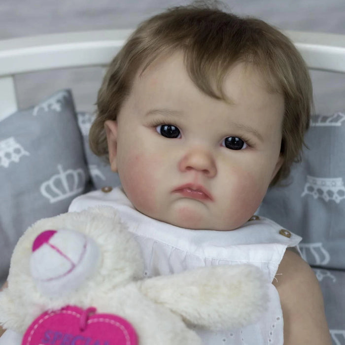 Bebê Reborn Elisa 60cm, boneca realista com corpo macio, olhos vivos, cabelo fio a fio e acessórios. Perfeita para crianças 3+, traz magia e ternura às brincadeiras!
